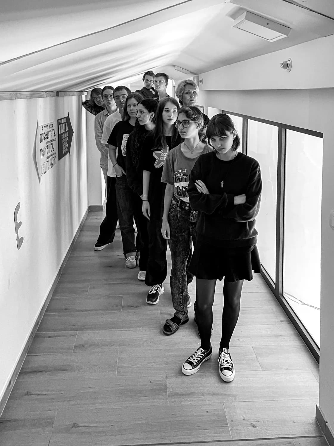Group of young people standing in a hallway